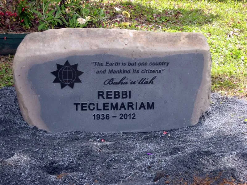 Natural-faced basalt boulder memorial with a raised inscription