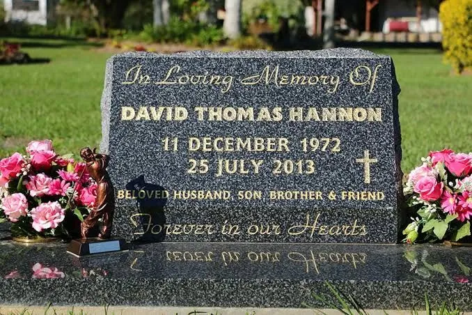 Grey granite sloped desk headstone with gold leaf lettering